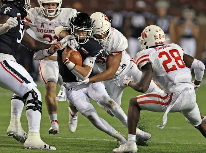Nov 7, 2020; Cincinnati, Ohio, USA; Cincinnati Bearcats quarterback Desmond Ridder (9) is tackled by Houston Cougars defensive lineman Logan Hall (92) at Nippert Stadium. Mandatory Credit: Jim Owens-USA TODAY Sports